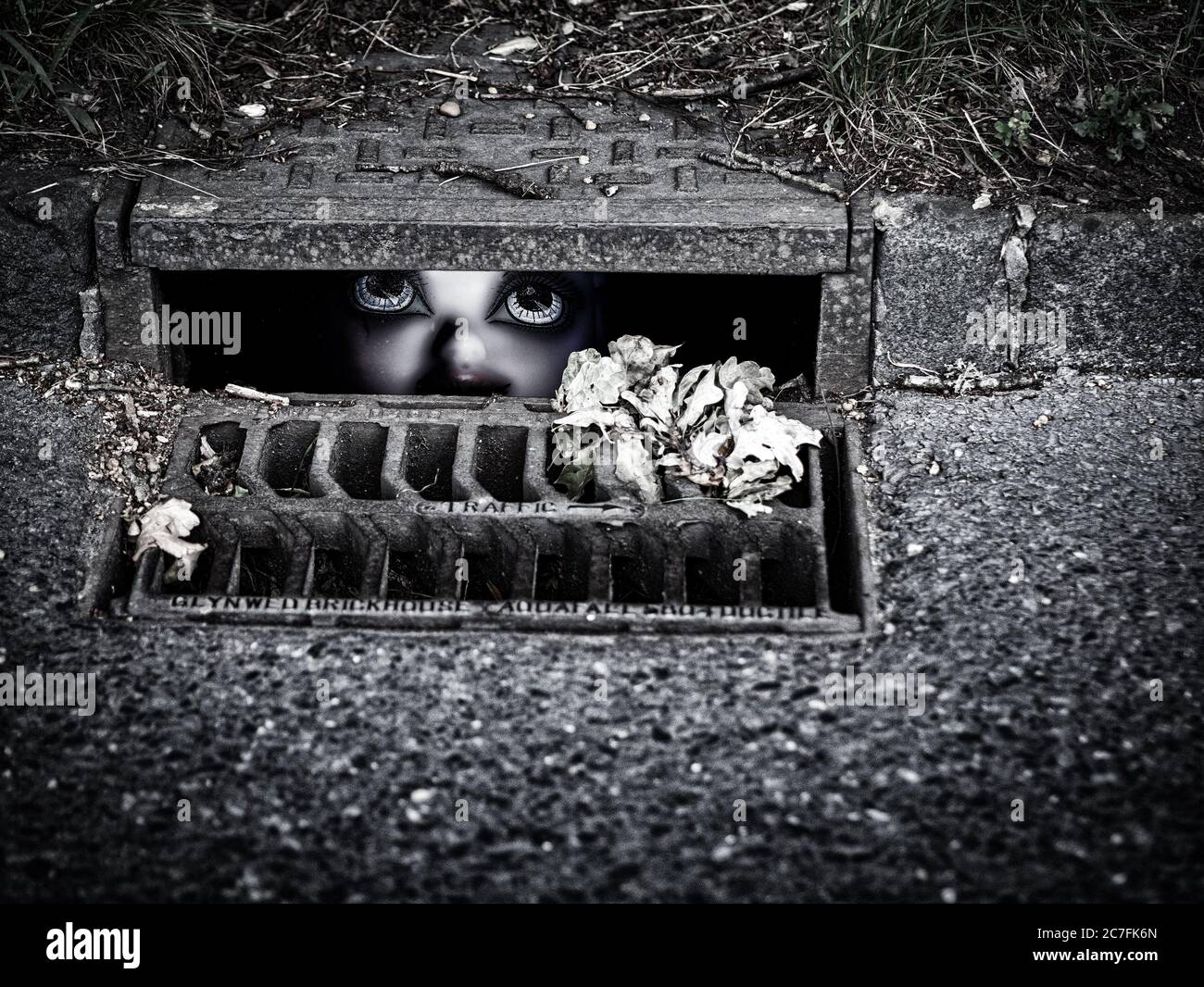 Doll hiding in a storm drain Stock Photo Alamy