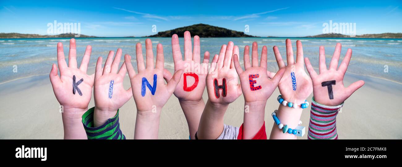 Children Hands Building Word Kindheit Means Childhood, Ocean Background Stock Photo