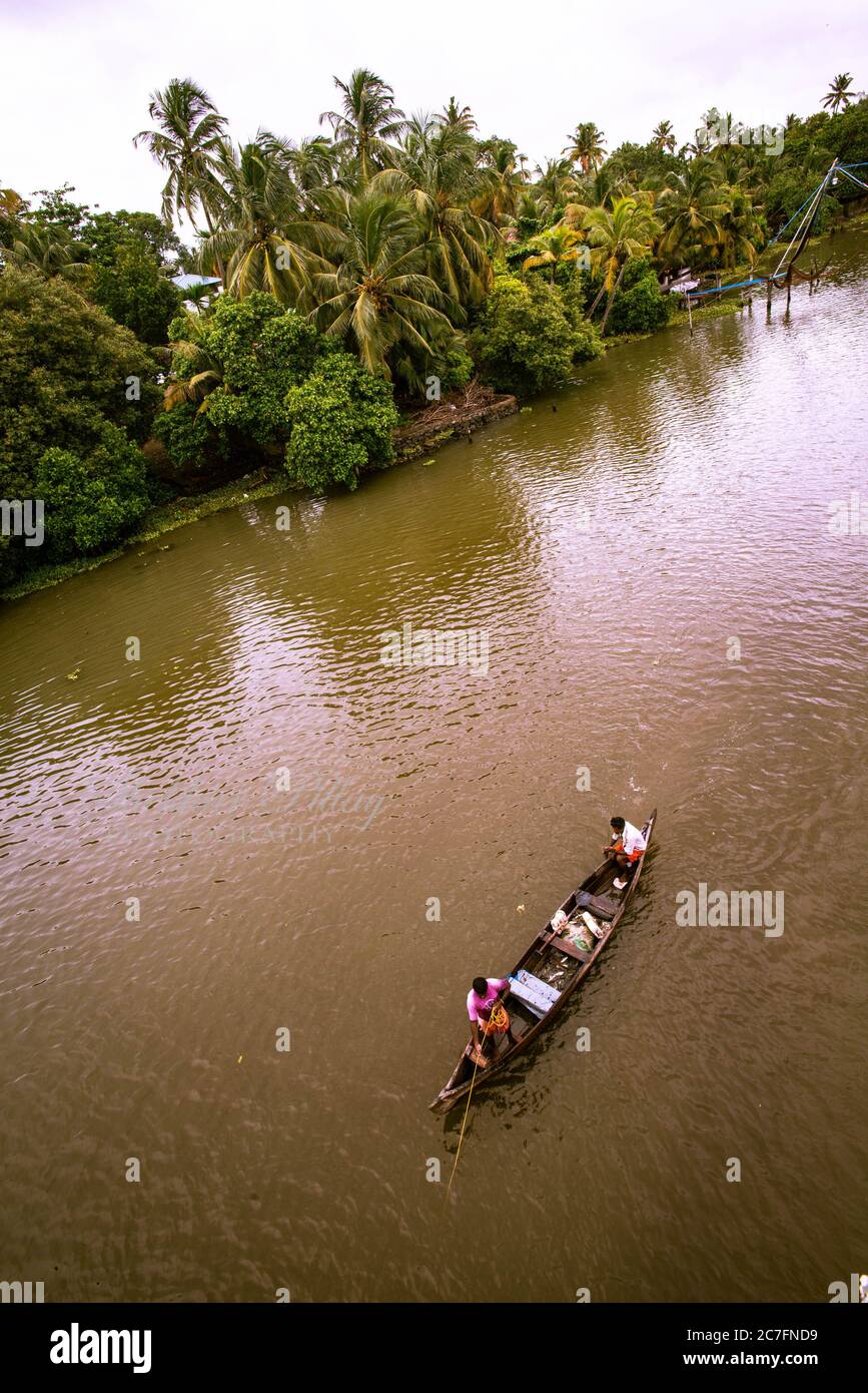 Scenic view of Fisherman fishing on traditional canoe boat in Kerala backwaters Kerala, India: July 2017 in Kerala, India. Stock Photo