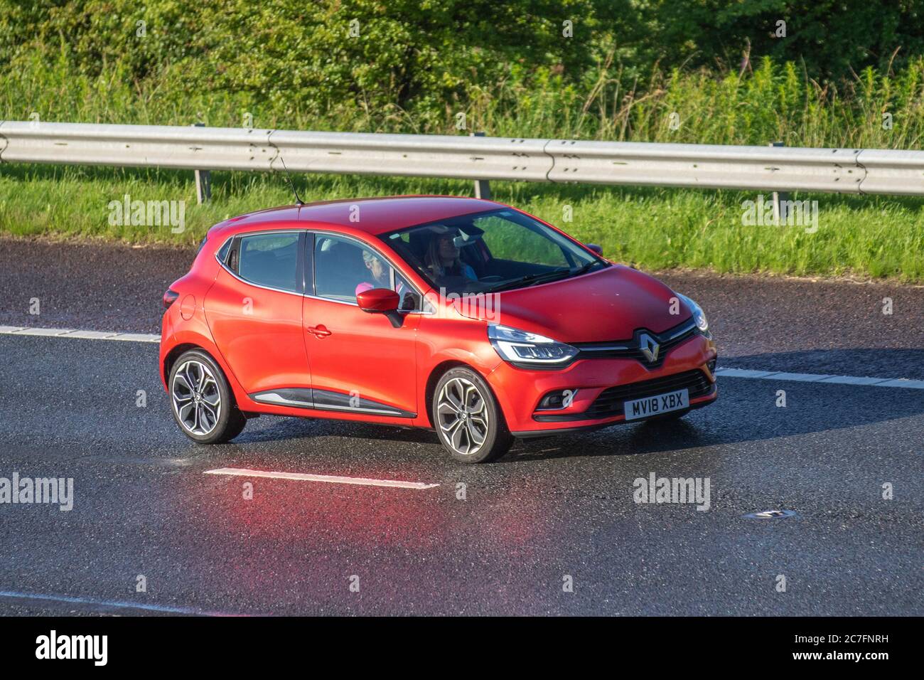 2018 red Renault Clio Dynamique S NAV TCE; Vehicular traffic moving vehicles, cars driving vehicle on UK roads, motors, motoring on the M6 motorway highway network. Stock Photo