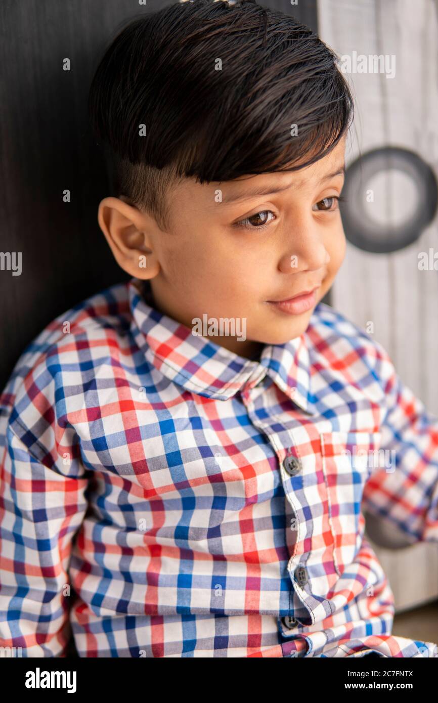 Portrait of cut little boy looking away and thinking Stock Photo ...