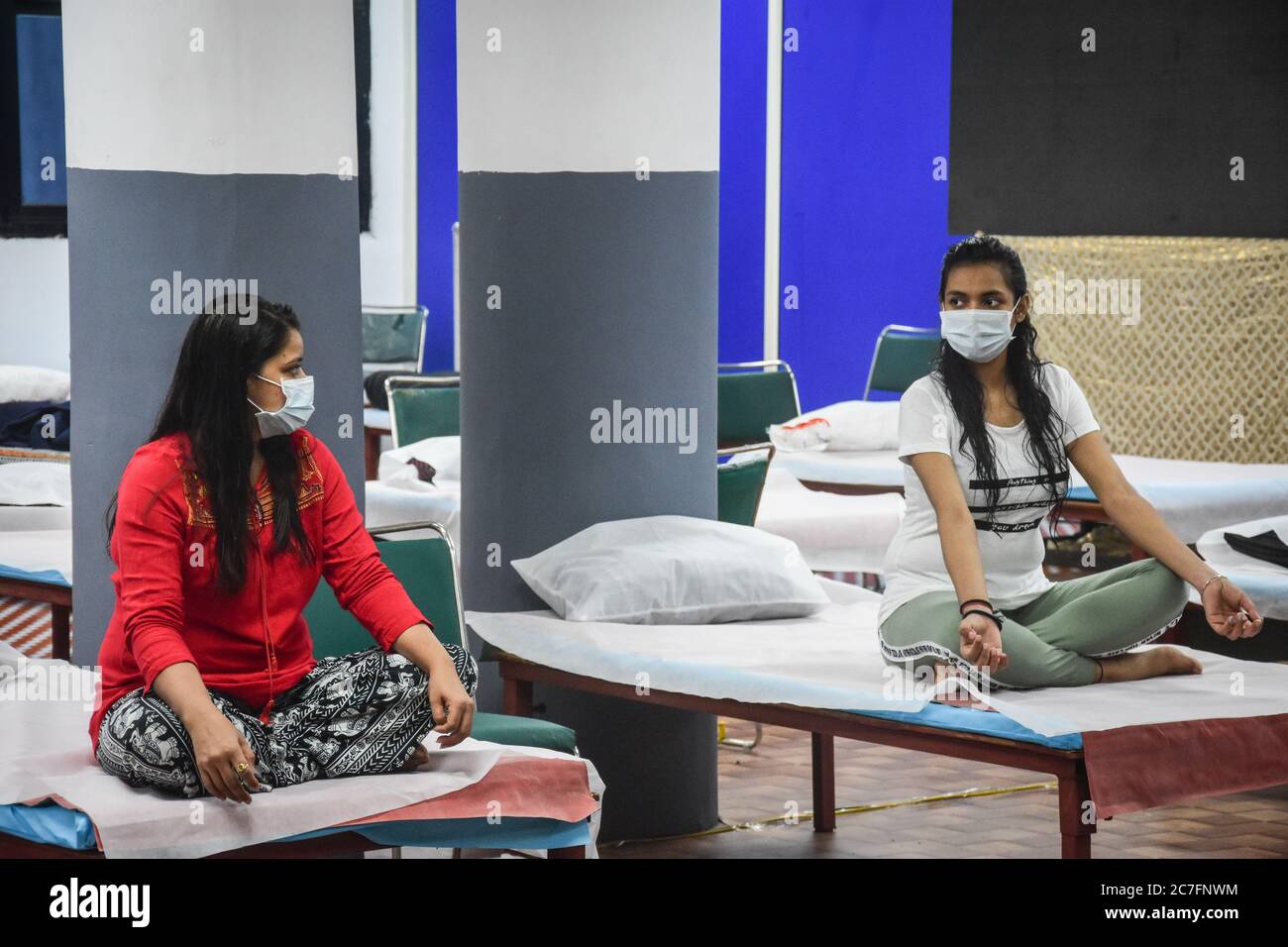Delhi, India. 17th July, 2020. Covid-19 infected patients perform yoga inside an isolation ward at the Commonwealth Games (CWG) Village sports complex which was temporarily converted into a coronavirus care centre in New Delhi. Credit: SOPA Images Limited/Alamy Live News Stock Photo