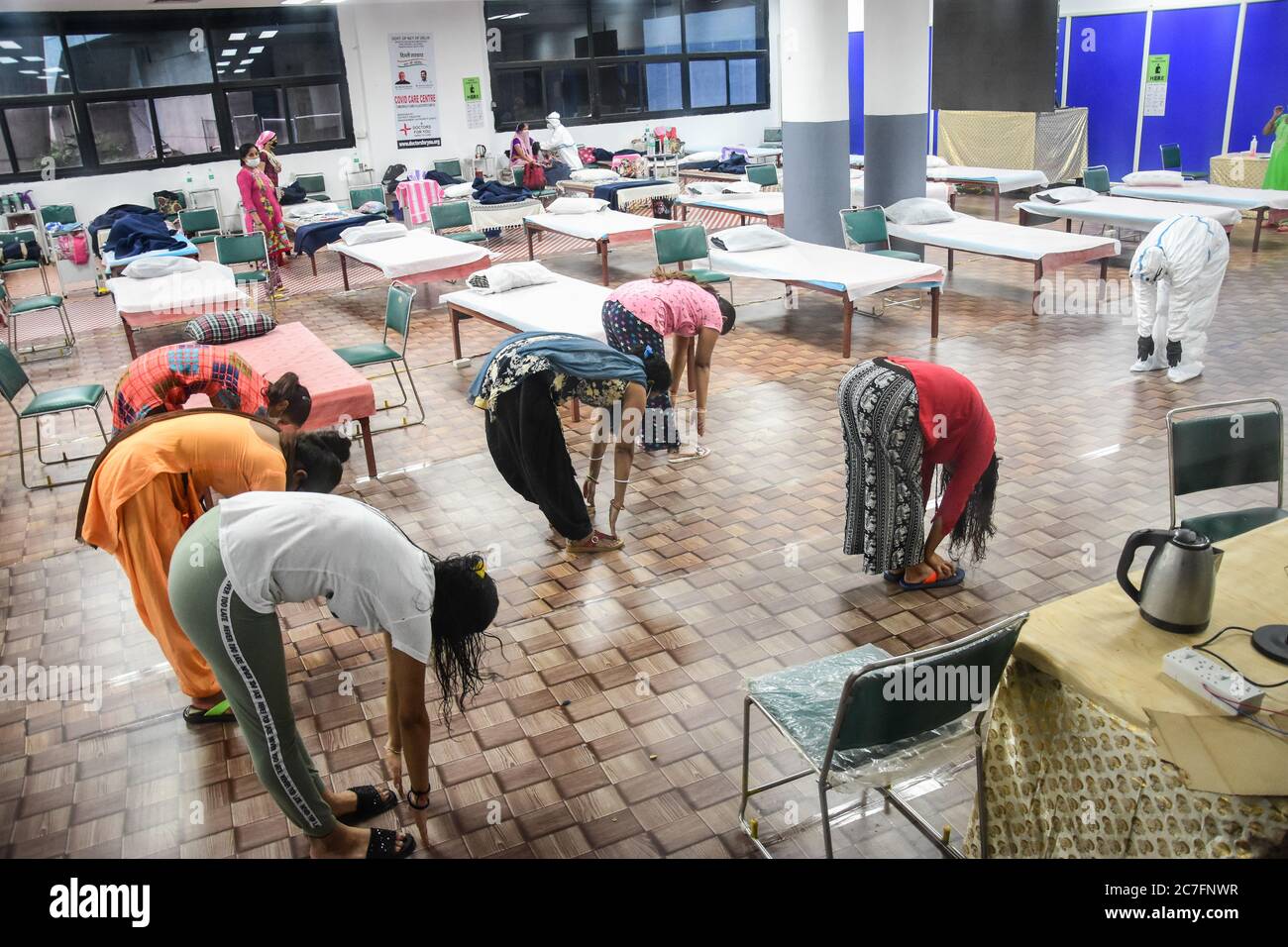 Delhi, India. 17th July, 2020. Covid-19 infected patients perform yoga inside an isolation ward at the Commonwealth Games (CWG) Village sports complex which was temporarily converted into a coronavirus care centre in New Delhi. Credit: SOPA Images Limited/Alamy Live News Stock Photo