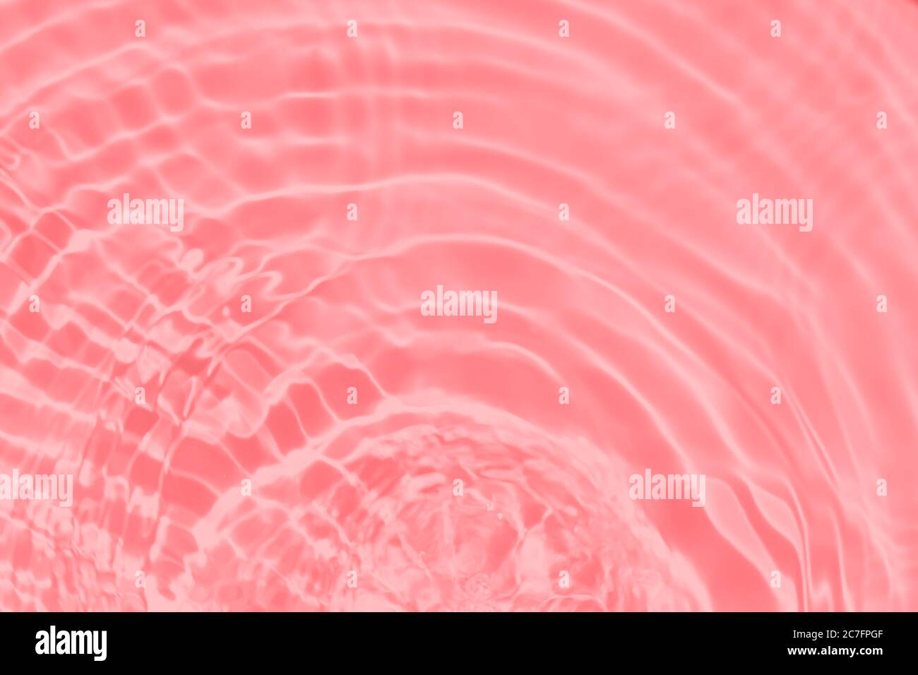 Closeup of pink transparent clear calm water surface texture with ...