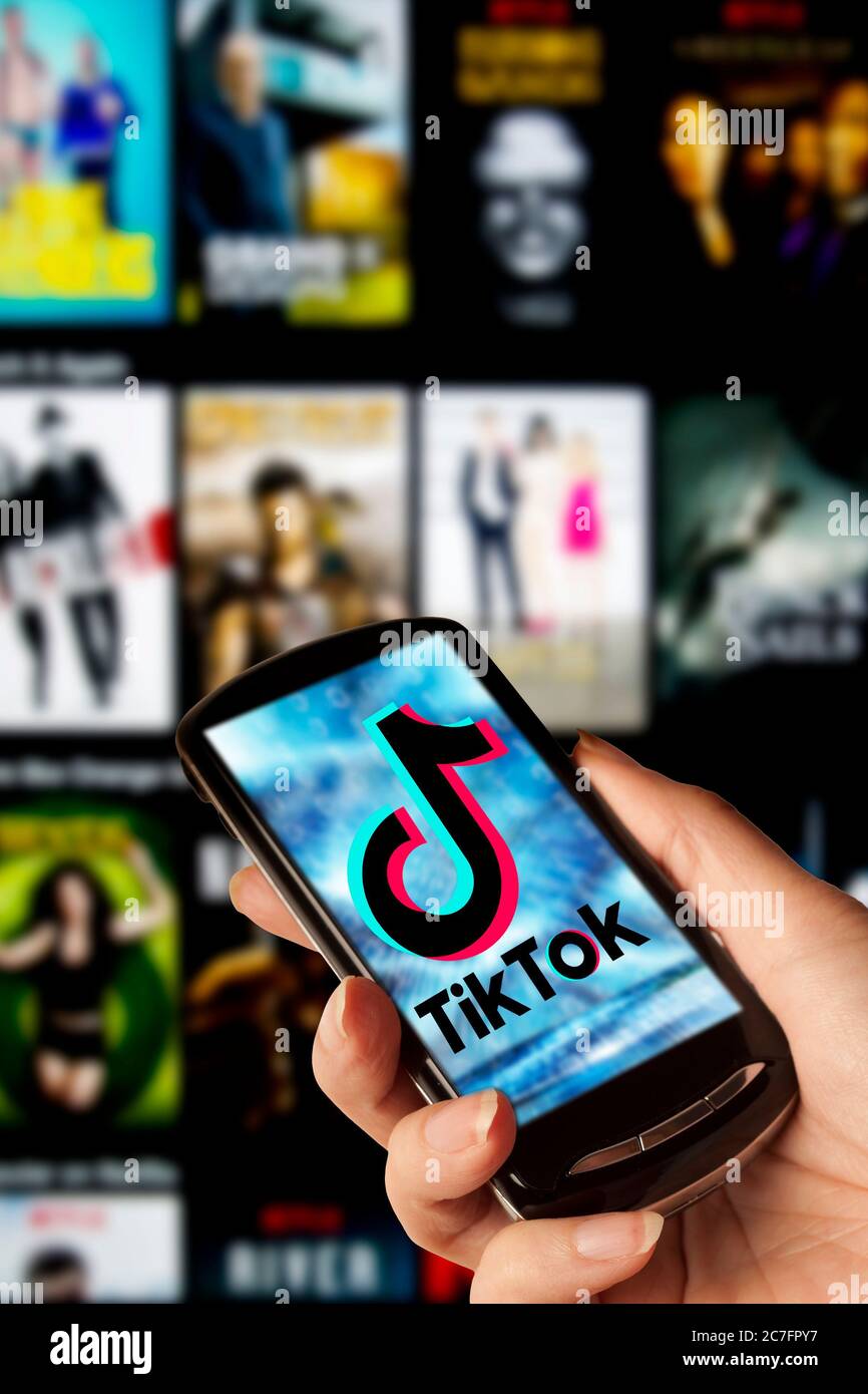 hand holding a smartphone with TikTok logo on screen Stock Photo