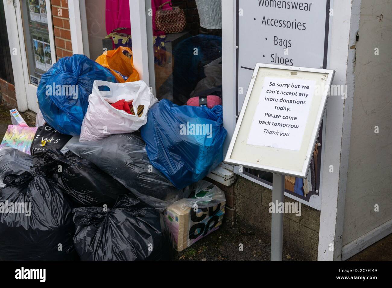 Charity bags outside a charity shop with a sign saying no more can be accepted today, Willen Hospice, Olney, UK; donations soar after lockdown eased. Stock Photo