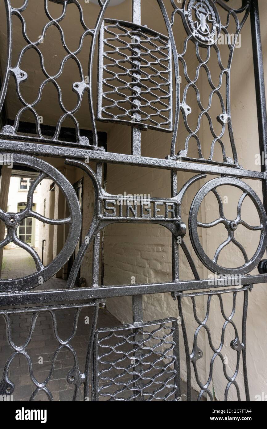 Black metal gate made up of old Singer sewing machine parts, Olney, Buckinghamshire, UK Stock Photo