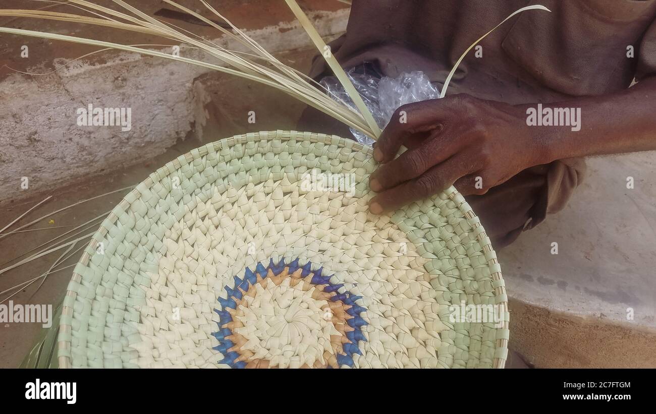 Person weaving a mat with palm leaves Stock Photo Alamy