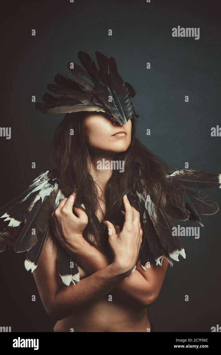 Woman with shaman's mask. Studio shot Stock Photo