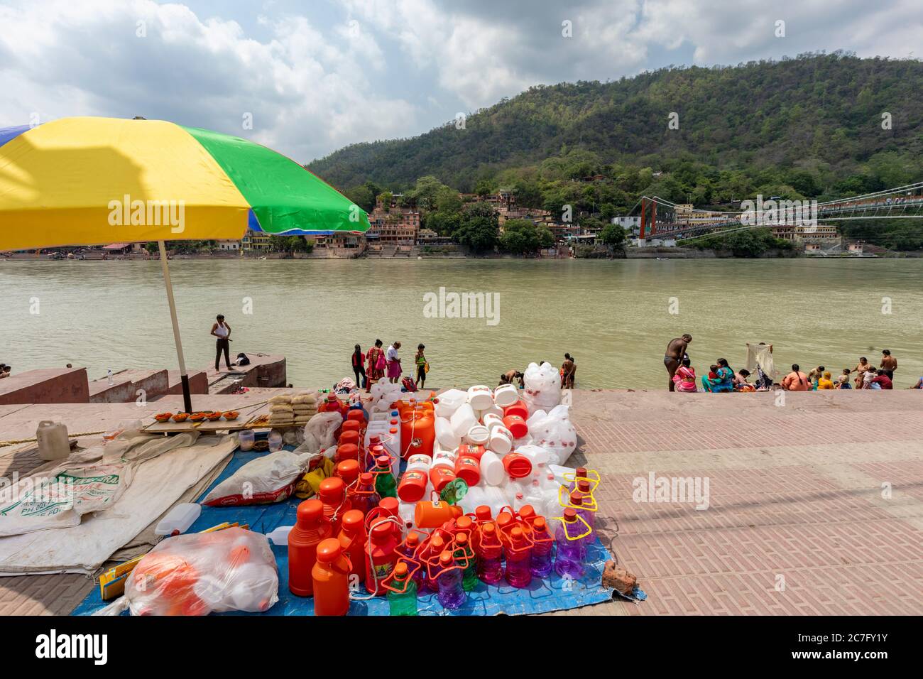 Plastic jugs on sale for collecting the water of River Ganges in the holy town of Rishikesh in northern India Stock Photo