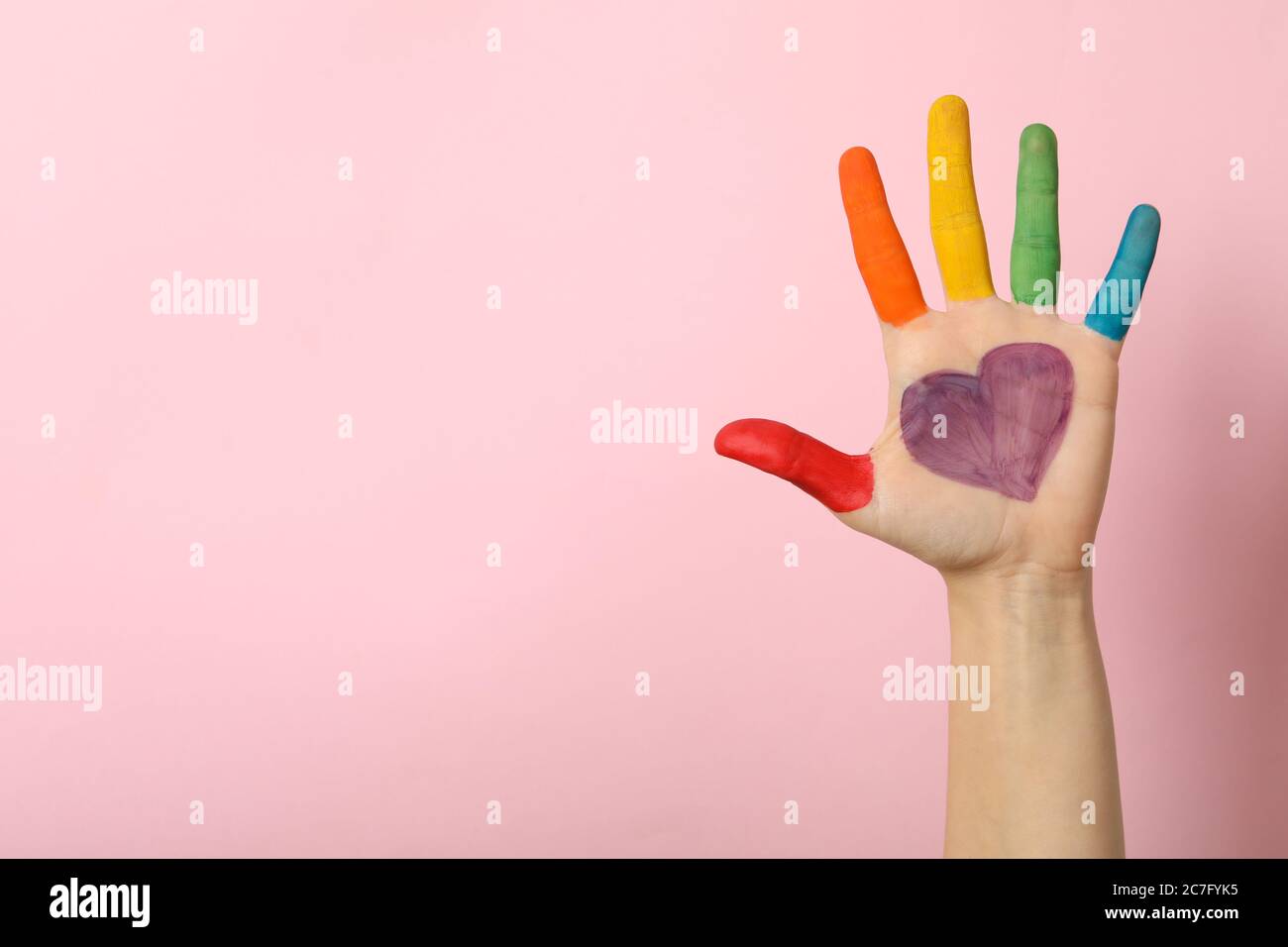 Female hand with LGBT colors on pink background Stock Photo