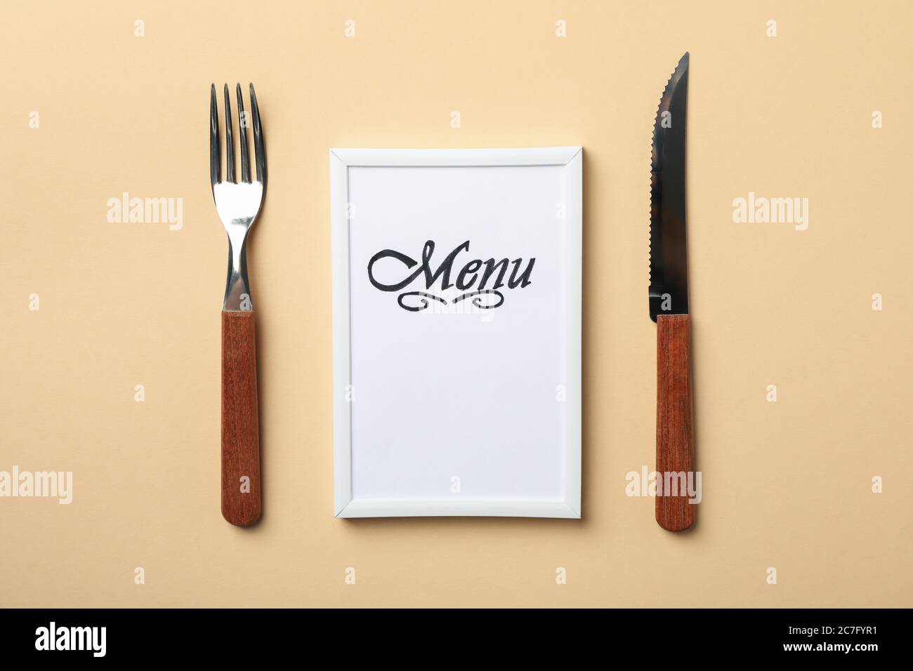 Frame with text Menu and cutlery on beige background Stock Photo