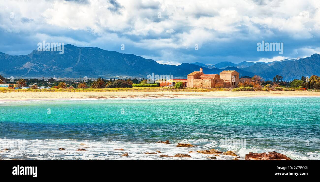 The Nora bay and beach, the medieval Sant'Efisio church near the shore and  mountains in the background. Location: Nora, Pula, Sardinia, Italy Europe  Stock Photo - Alamy