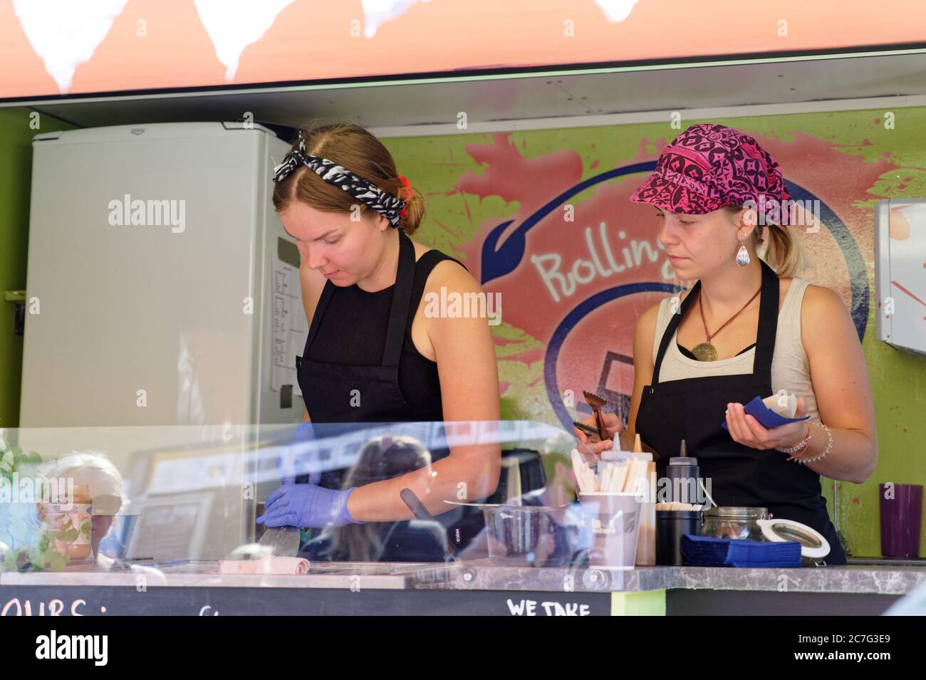 Woman preparing rolled ice cream at an rolling ice bar in Helsinki