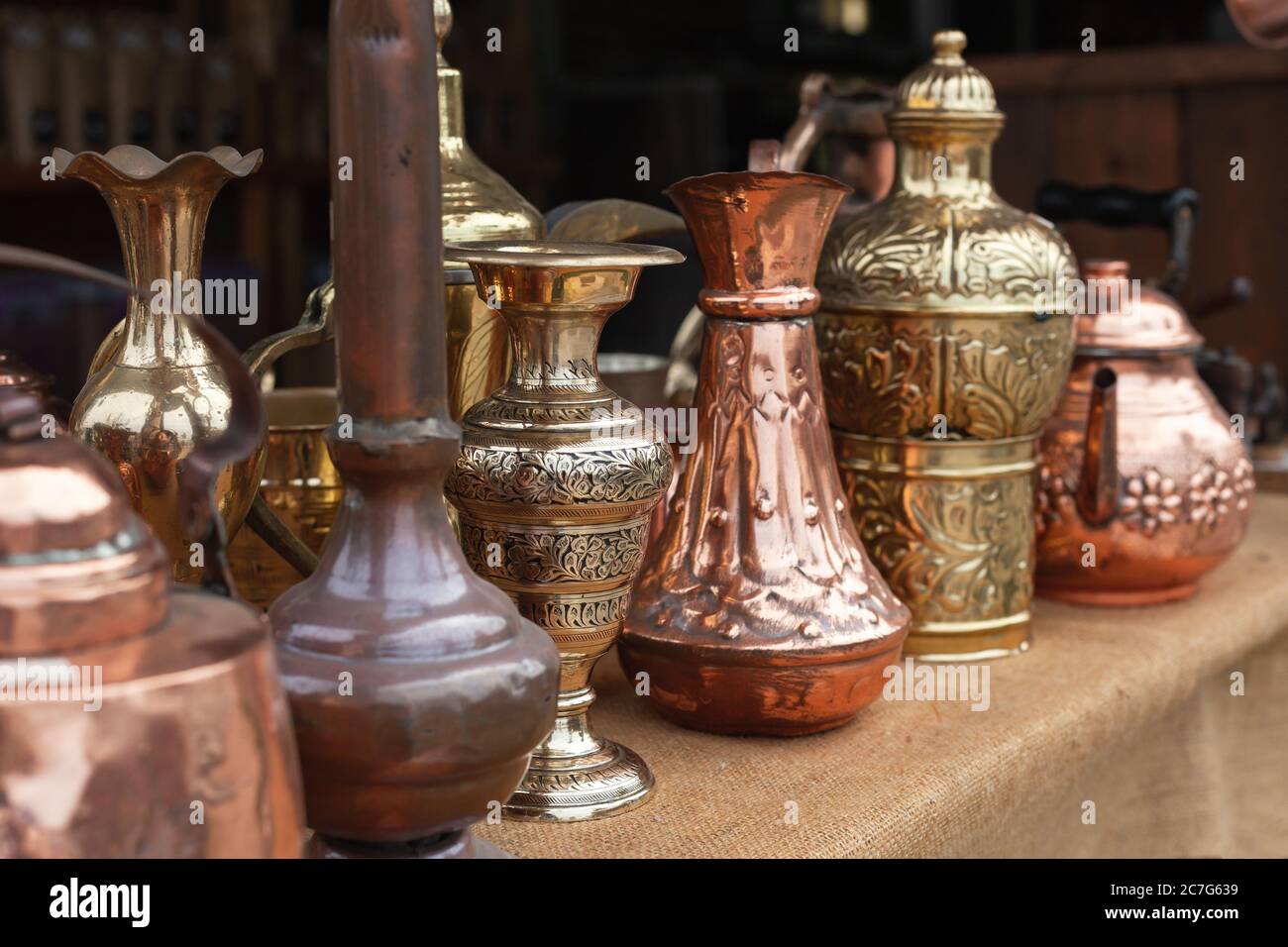 Assortment of stylized Oriental copper dishware standing on a counter of a gift shop in Jordan Stock Photo