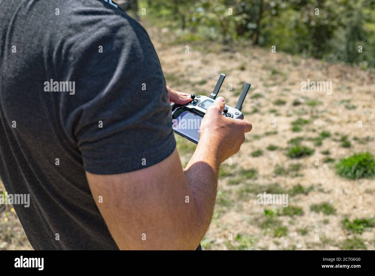 Man operating a drone with remote control.. Close up. Selective focus. Stock Photo