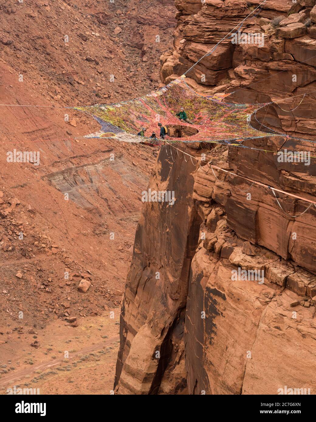 USA, Utah, Moab, Base jumpers prepare to jump from the Mothership Spacenet  suspended from the cliffs 950 vertical feet above the valley floor at  Mineral Canyon Stock Photo - Alamy