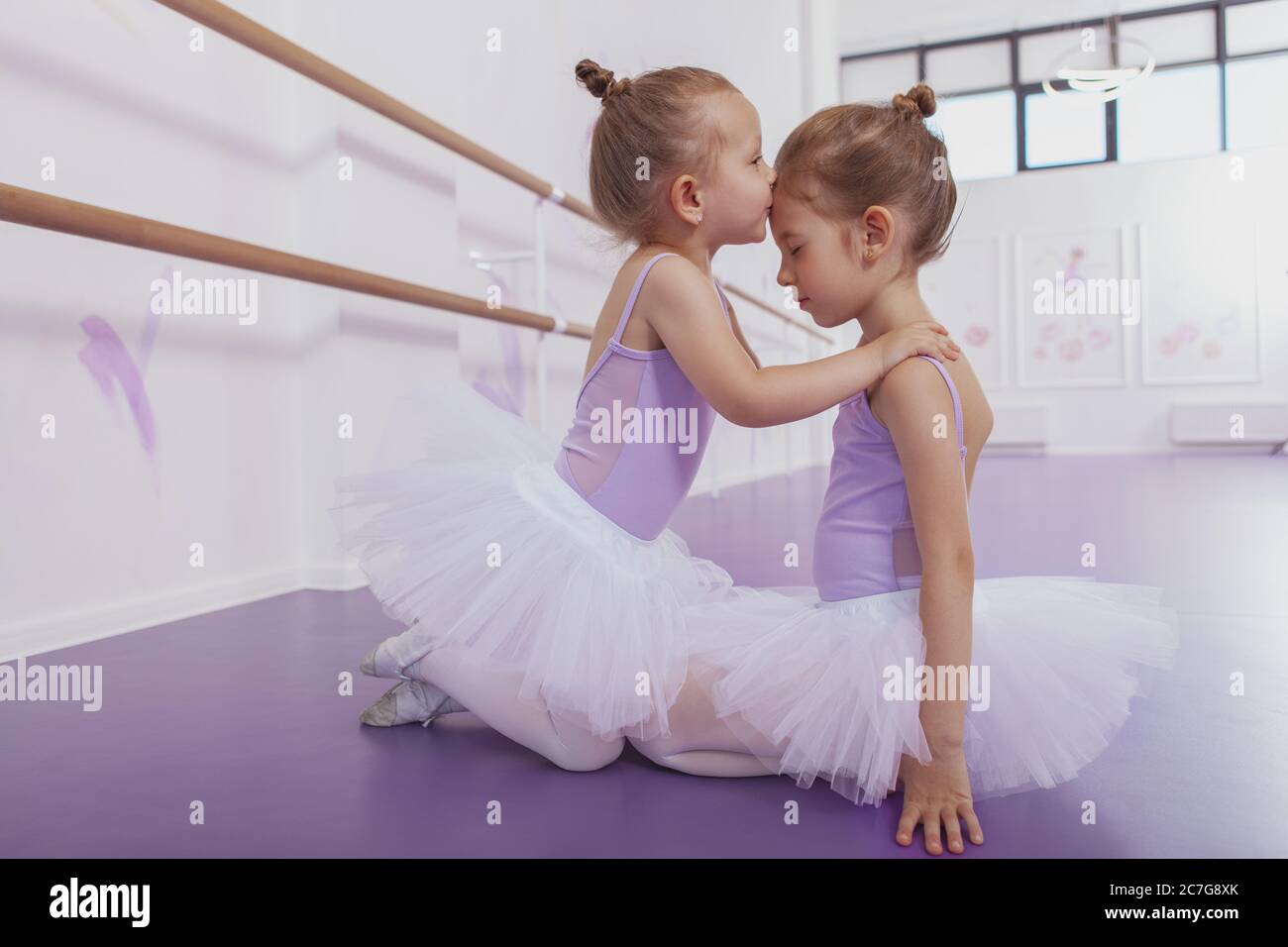 Full length shot of cute little ballerina girl in tutu sirt kissing her  older sister on the forehead, copy space. Charming little ballerinas  cuddling Stock Photo - Alamy