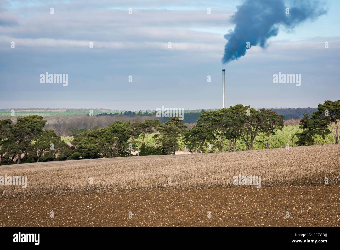 Pollution countryside, view of a power plant chimney emitting smoke in Breckland, rural Norfolk, England, UK Stock Photo