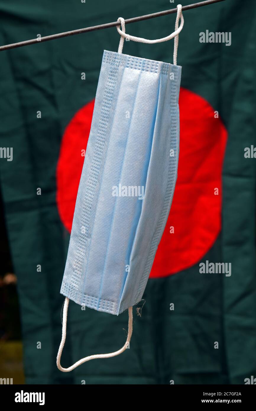 surgical face mask in front of national flag of Bangladesh Stock Photo