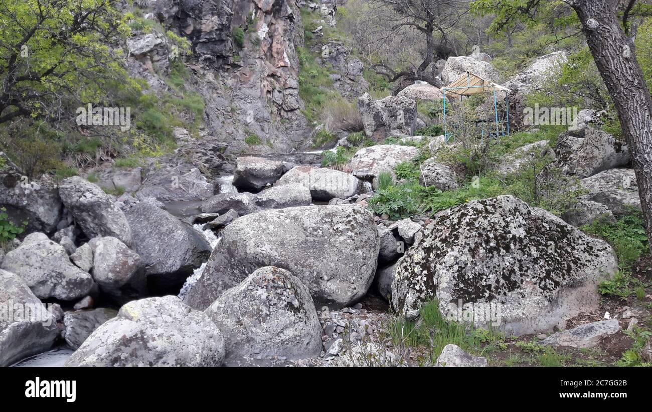 Low angle shot of big rocks in the grass covered valley Stock Photo - Alamy