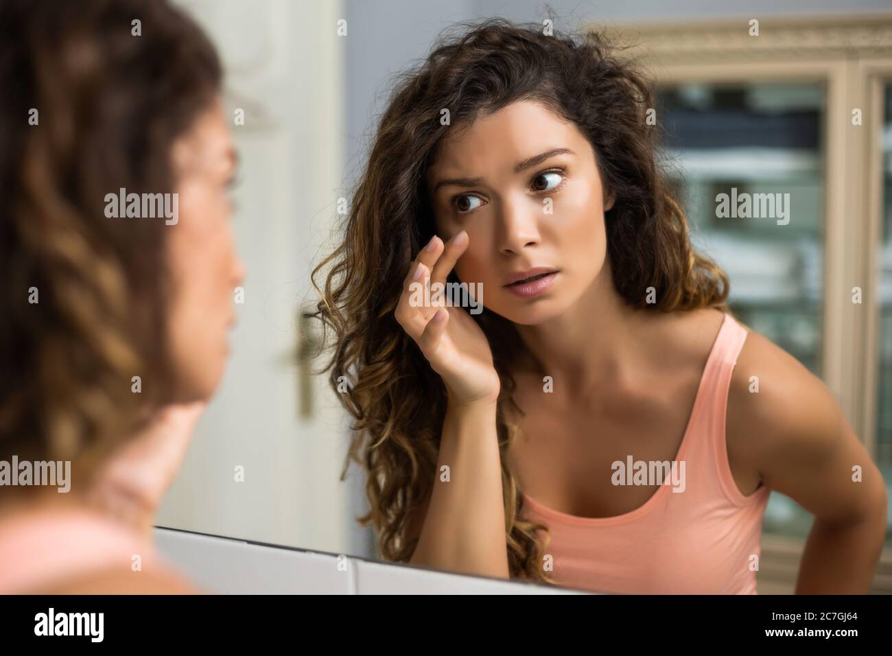 Tired woman looking her eye bags in the bathroom Stock Photo Alamy