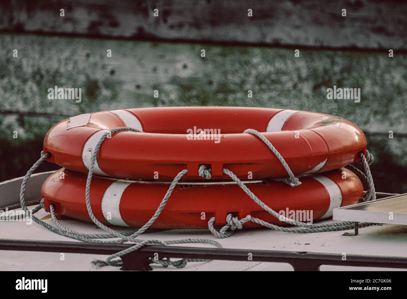orange life rings stacked on the deck of a boat or yacht Stock Photo