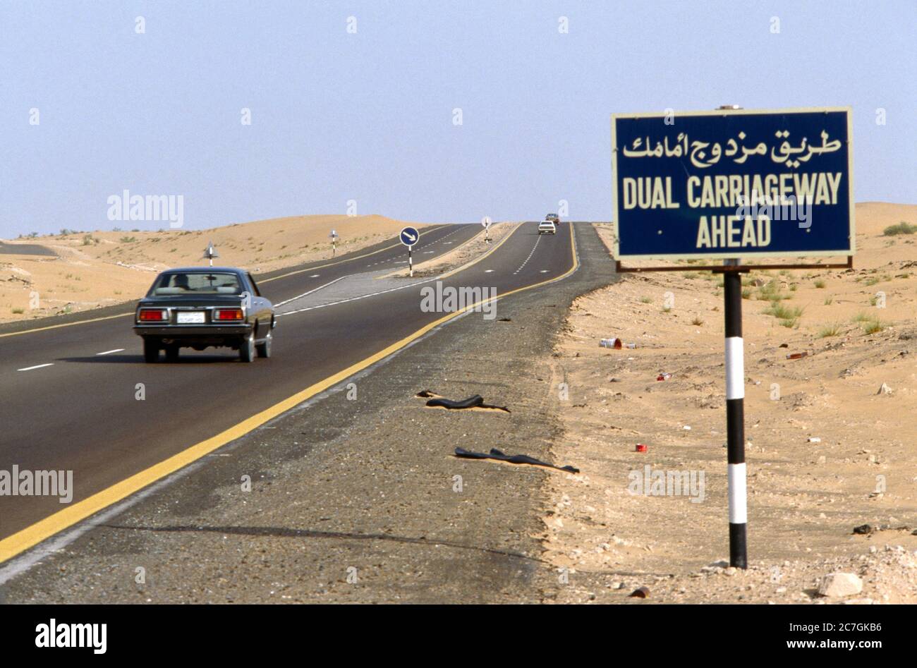 Dubai UAE Rubbish On The Side Of The Road In The Desert Dual Carriageway Ahead Stock Photo