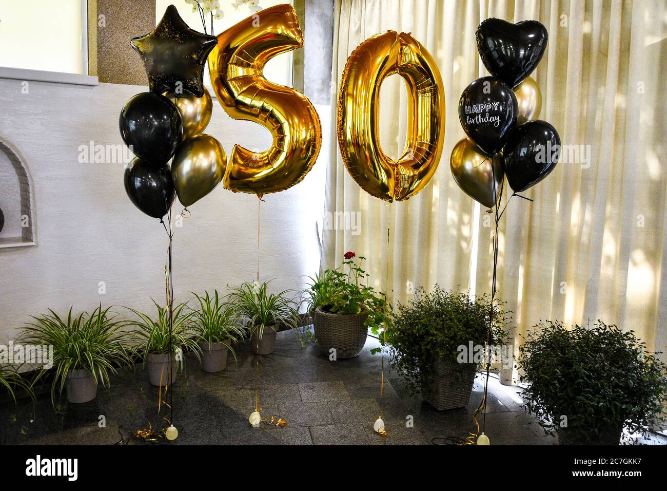 Gold inflatable balls in the form of a figure 50, Birthday anniversary party. Gold 50th Birthday Party Balloons Stock Photo - Alamy