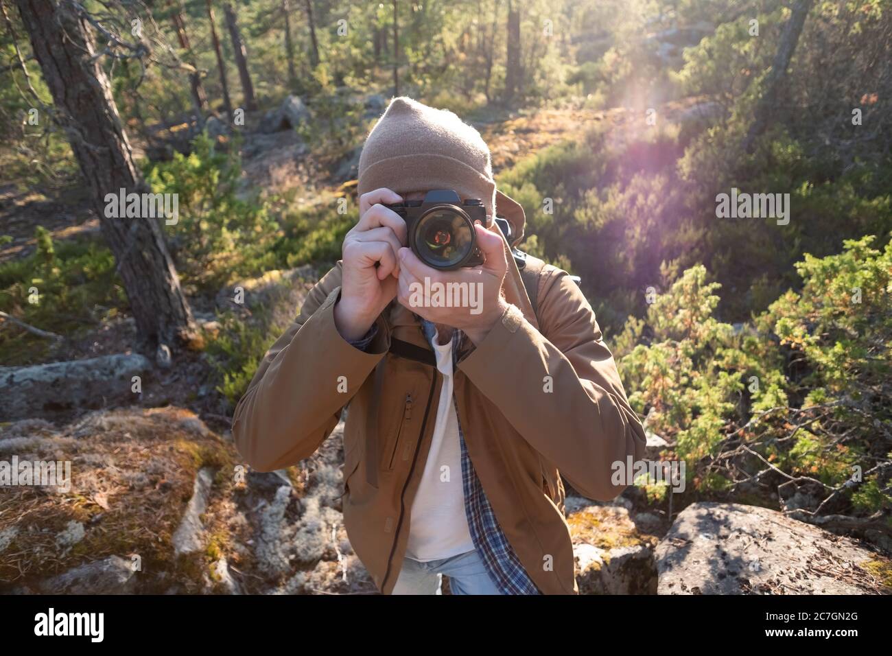 Male tourist using digital camera outdoors in a forest Stock Photo