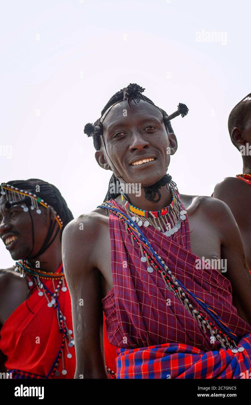 Maasai man wearing traditional attire, in a traditional dance, in Maasai Mara National Reserve. Kenya. Africa. Stock Photo