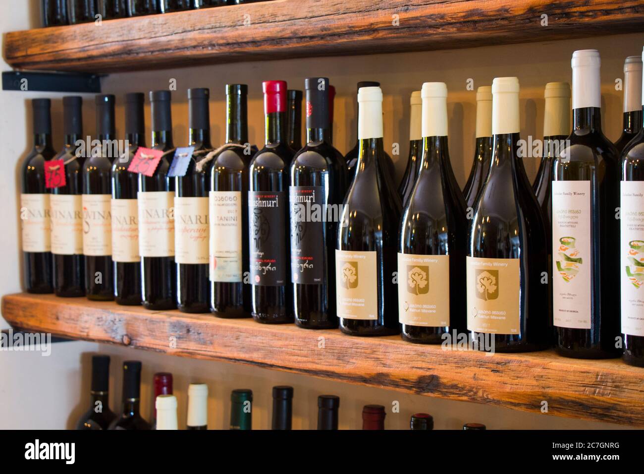 Wine bottles on the shelf, wine shop interior, winery in Tbilisi