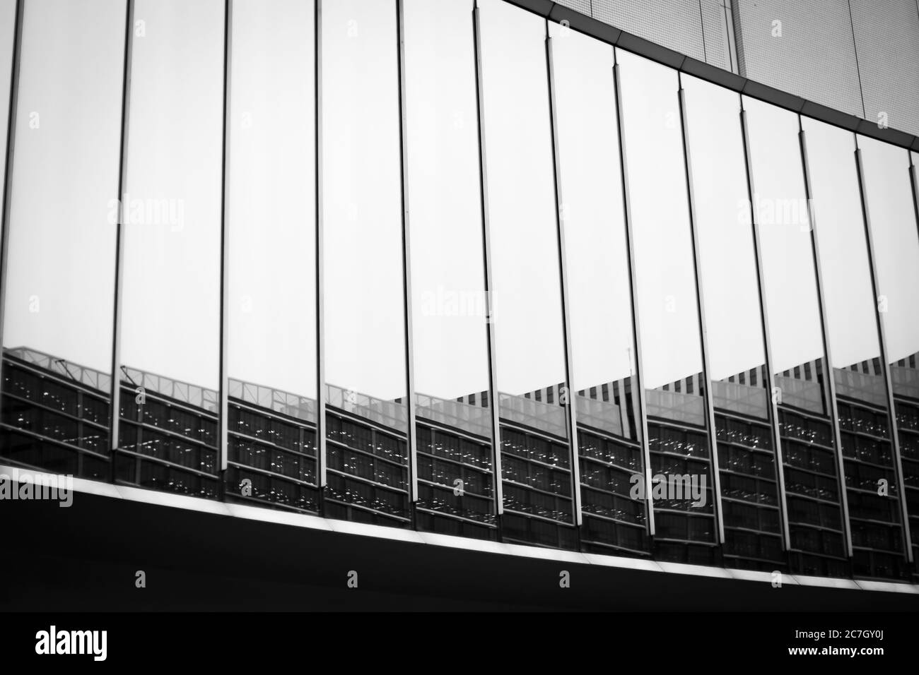 Reflection on the curved glass of the modern building. Black and White. Landscape orientation. Stock Photo