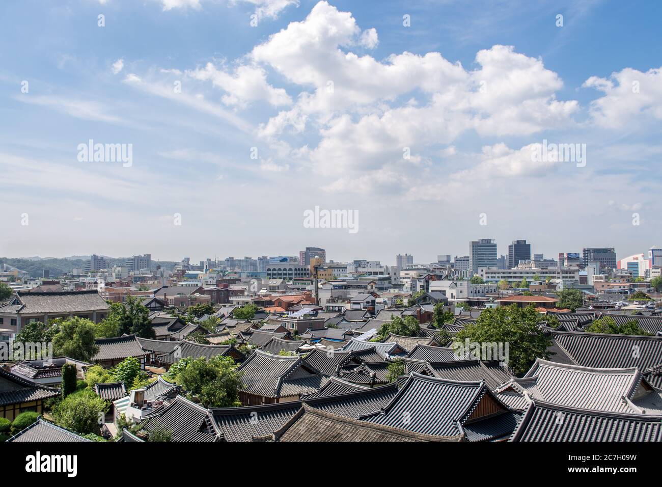 Jeonju, South Korea - A view of Hanok Village, Korean traditional house village behind the business district with modern office buildings. Panorama. Stock Photo