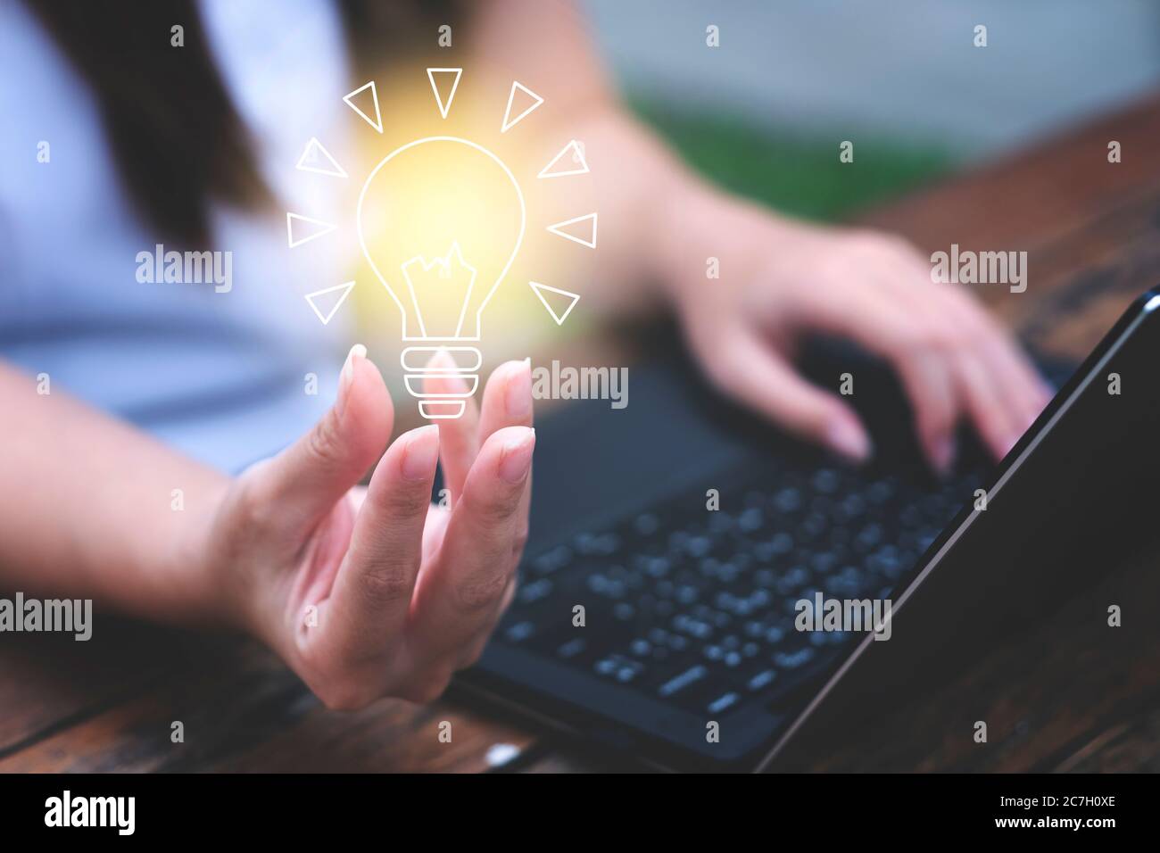 Young woman holding a light bulb. Get ideas, innovative technology and creativity concept Stock Photo