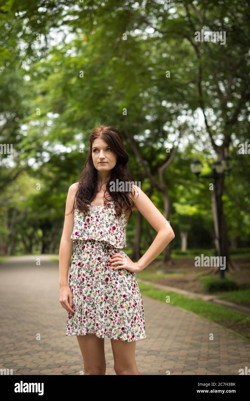 Portrait of young beautiful woman at the park outdoors Stock Photo - Alamy