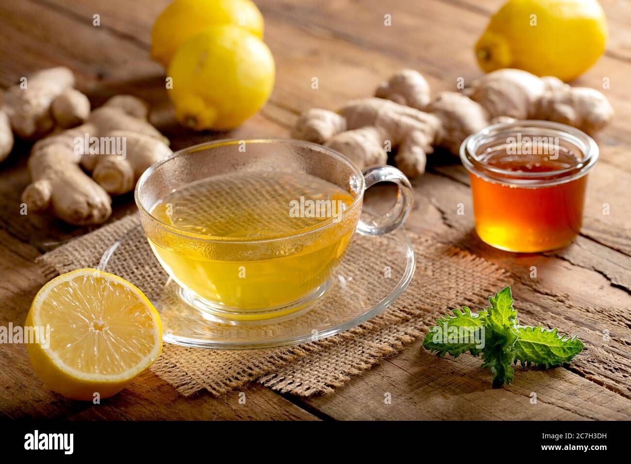 Energizing ginger tea with lemon and honey on old wooden table Stock Photo