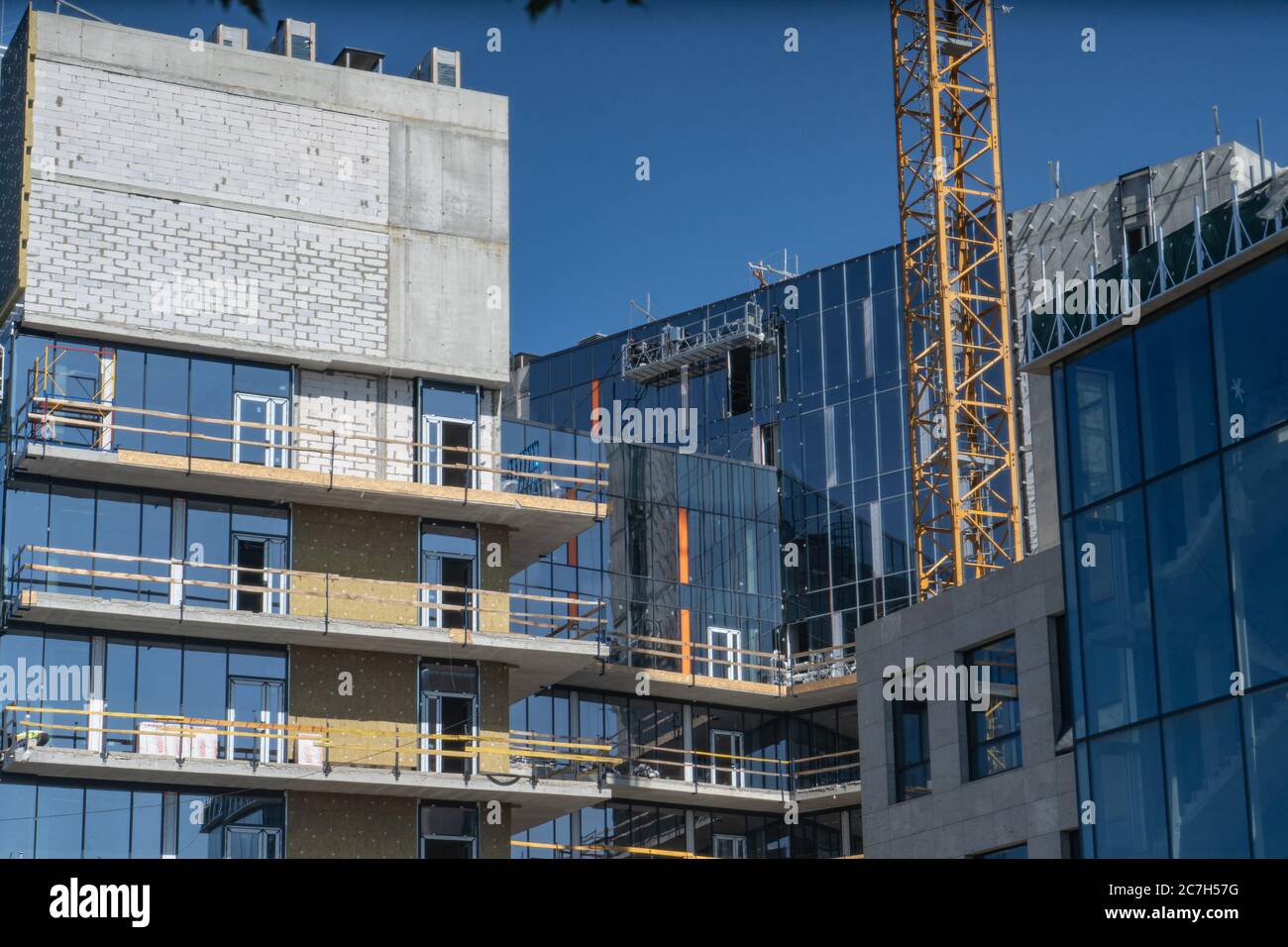 High-rise building at construction site on sunny day. Construction of a new residential complex. June 2020. Kiev, Ukraine Stock Photo