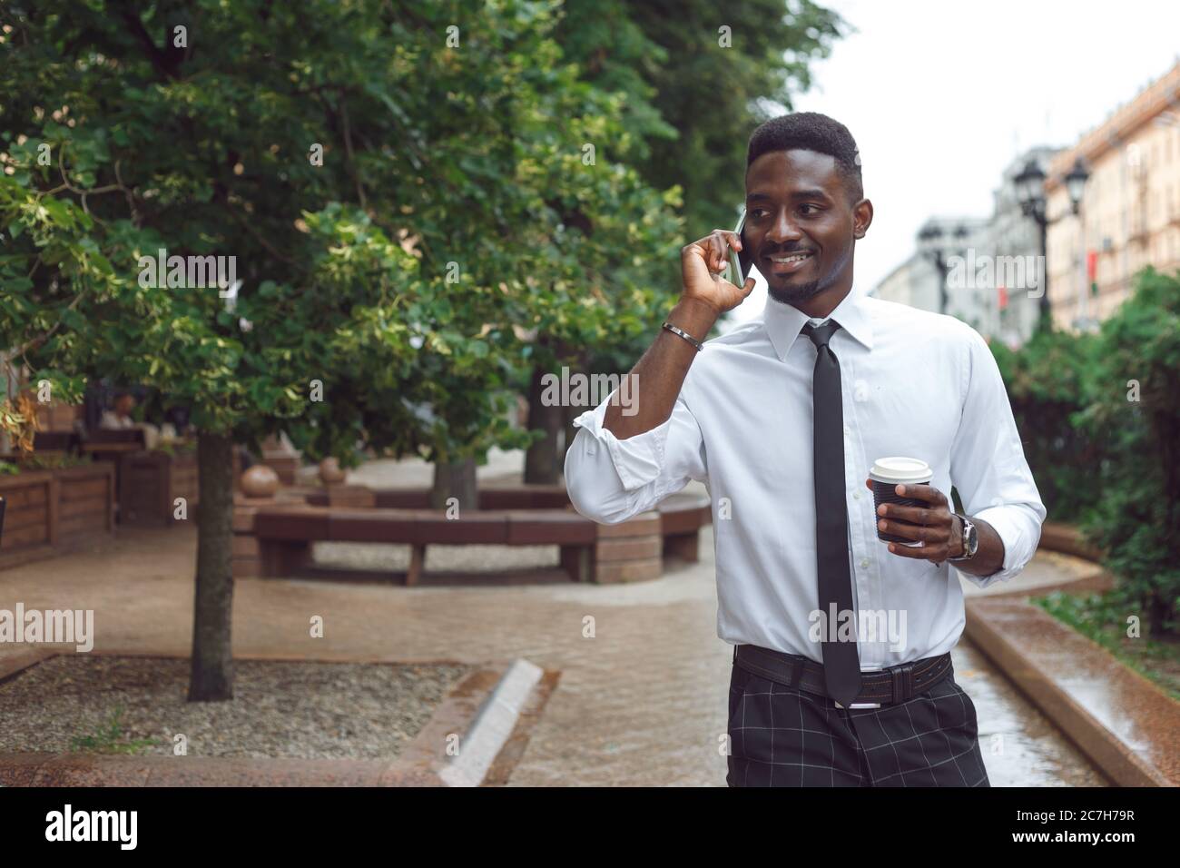 Young black african man walking hi-res stock photography and images - Alamy