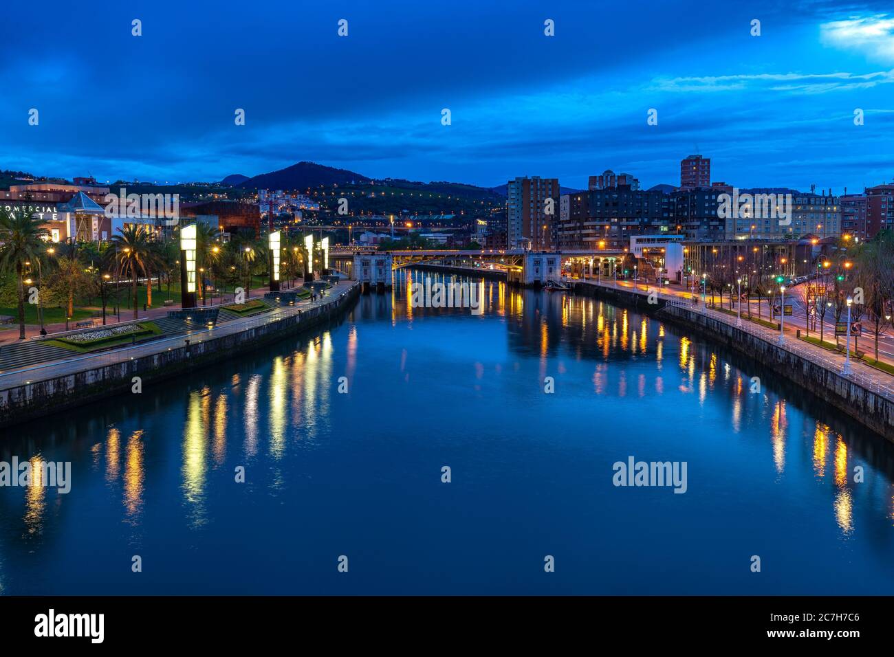 Europe, Spain, Basque Country, Vizcaya Province, Bilbao, view from the Pedro Arrupe Bridge over the Nervión and Bilbao at the blue hour Stock Photo