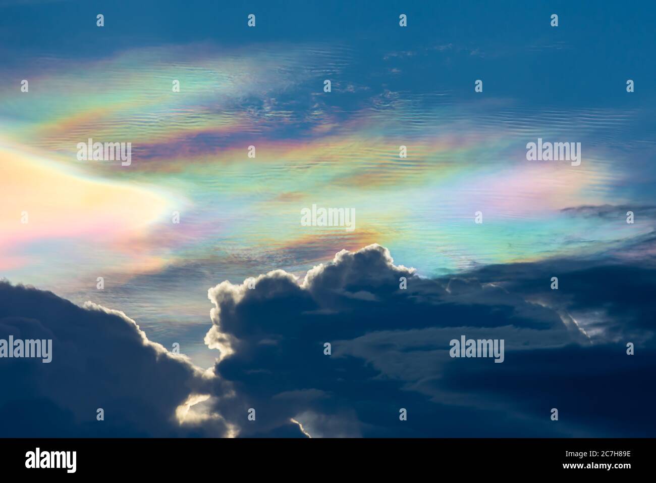 The beauty of the rainbow clouds Above the black clouds in the evening. Stock Photo