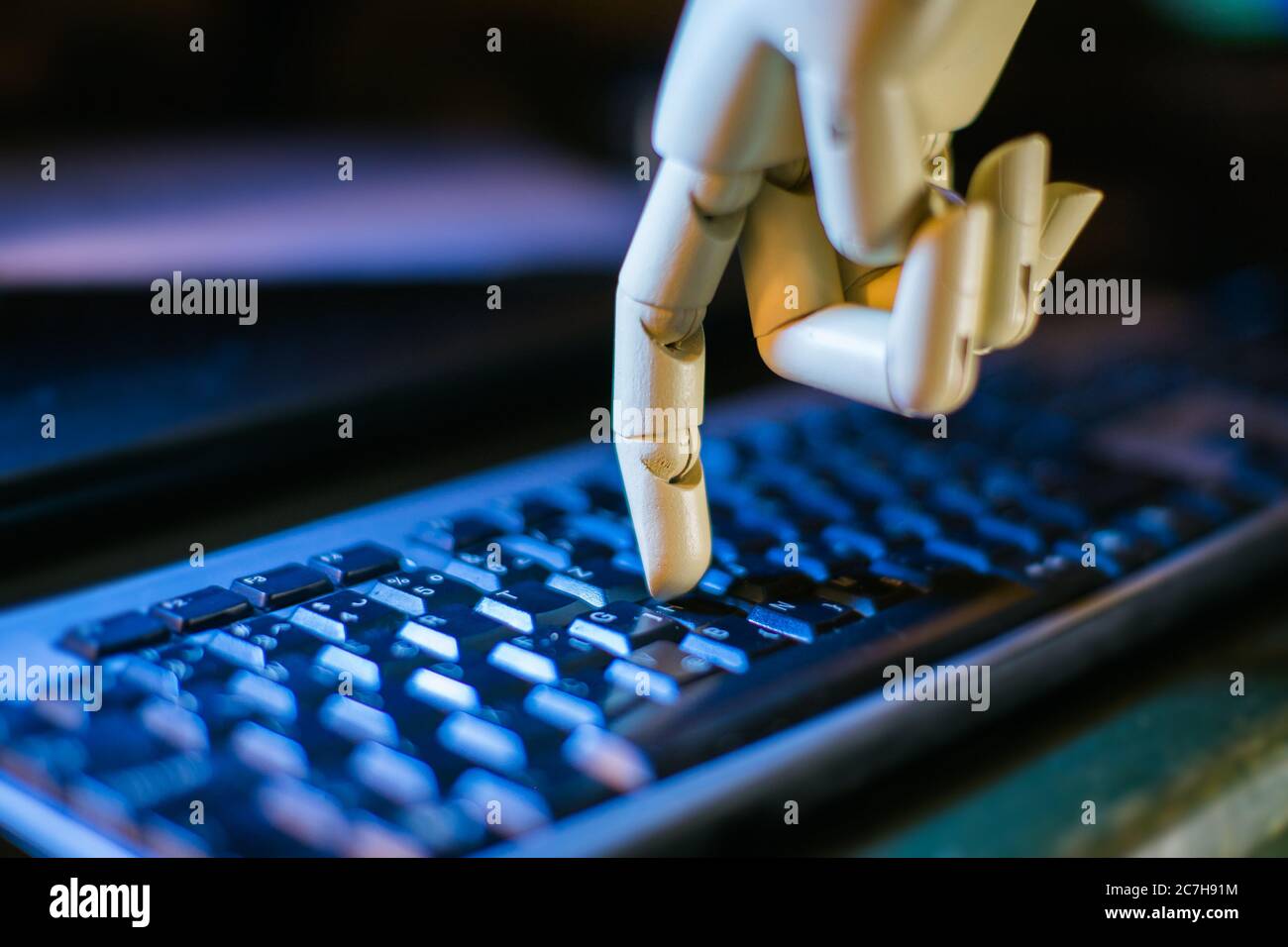 robotic hand typing on a computer keyboard Stock Photo - Alamy