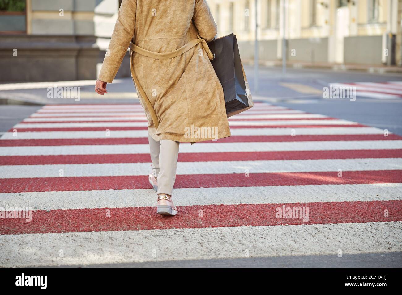 Female is walking at the pedestrian crossing Stock Photo - Alamy