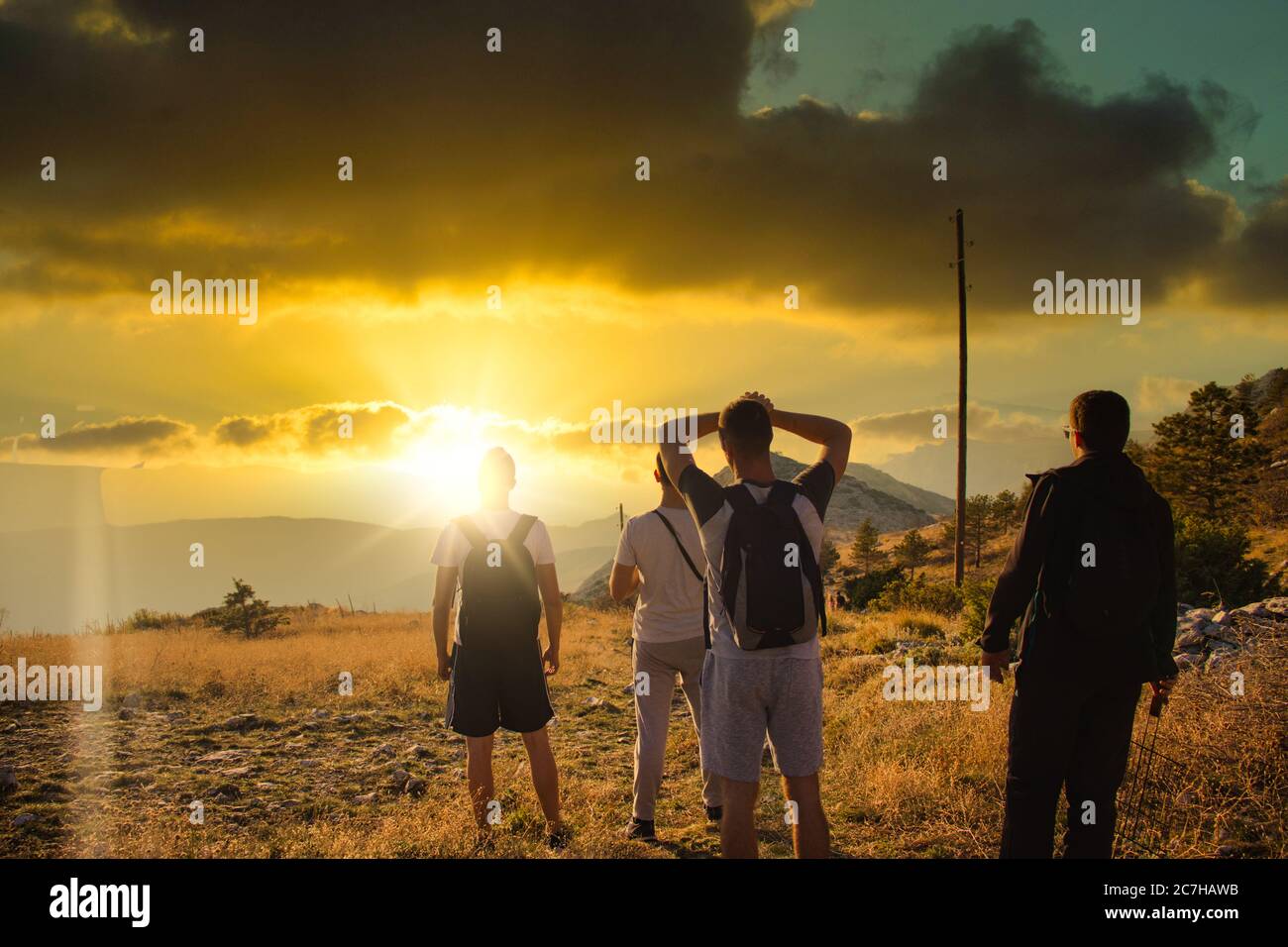Four friends seen from behind, hiking on top of the Mosor mountain in ...
