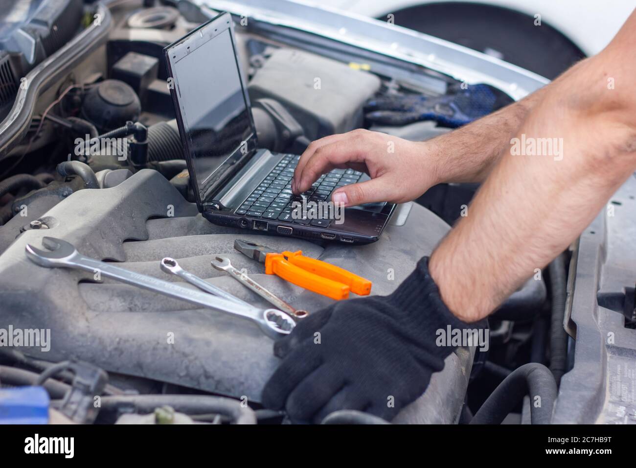 auto mechanic diagnosing car with black laptop Stock Photo Alamy