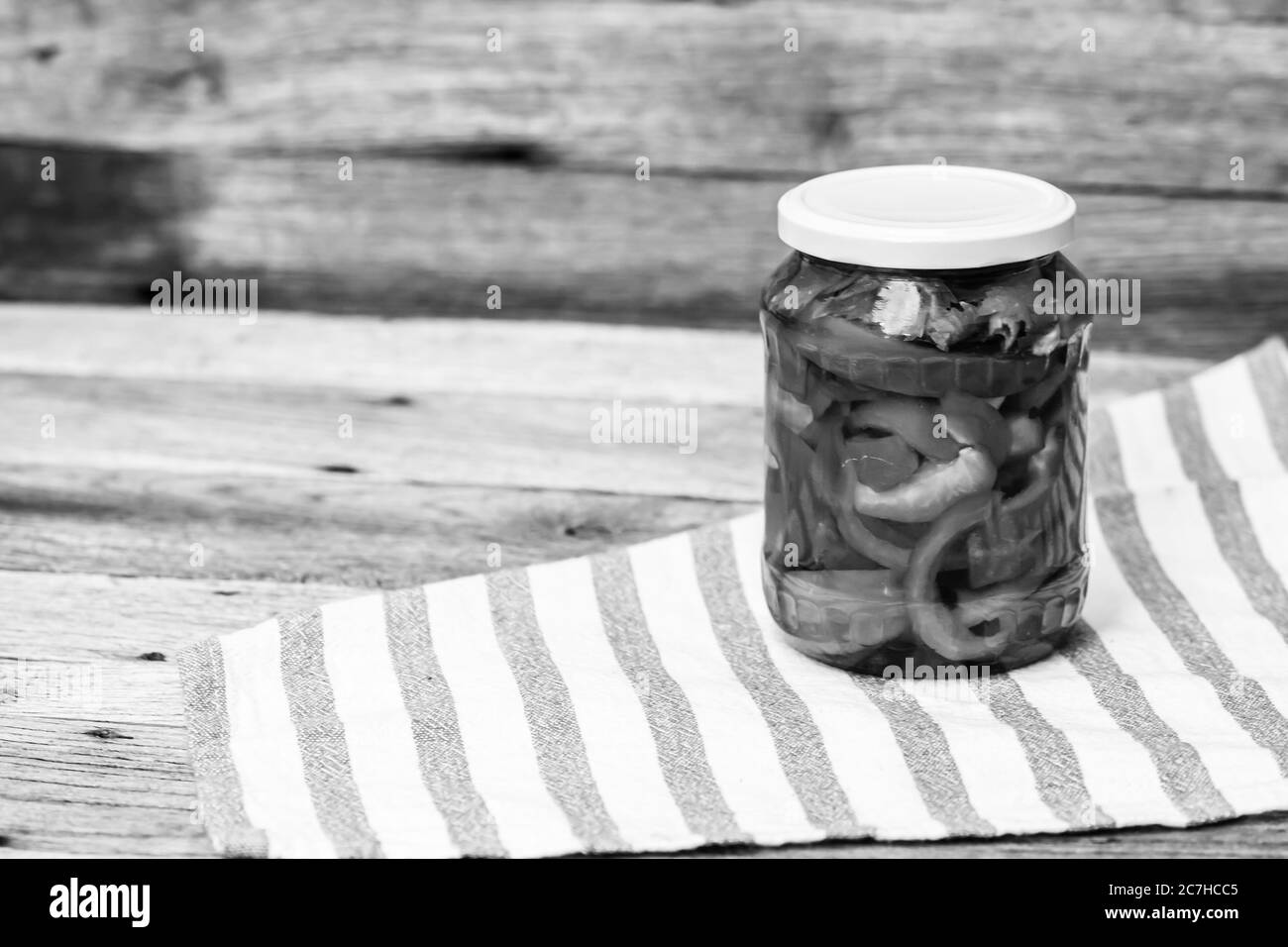 Glass jar with pickled red bell peppers.Preserved food concept, canned