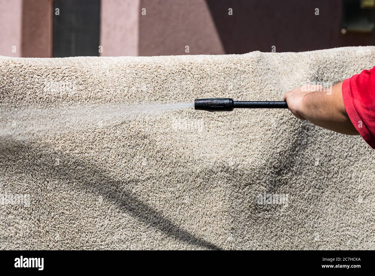 Close up of washing carpets with high pressure washer. Cleaning the