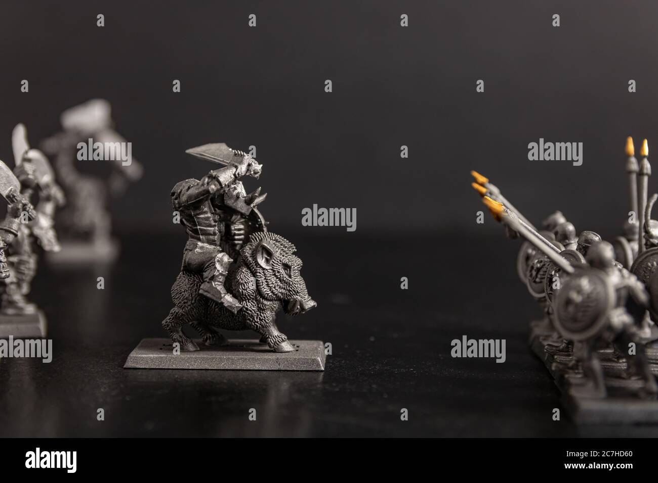 Grayscale selective focus shot of a creature figurine near Sparta soldiers figurines Stock Photo