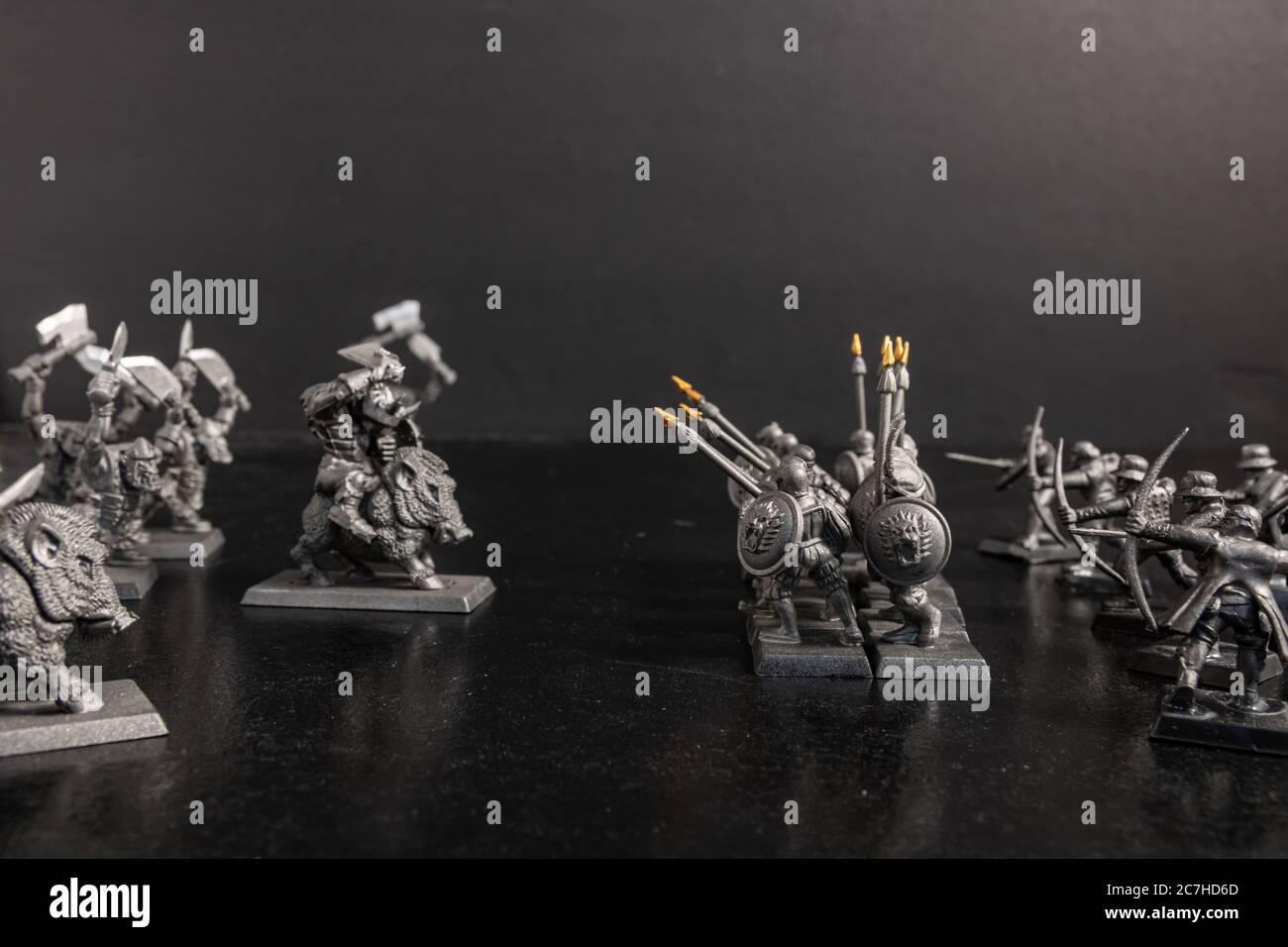 Grayscale selective focus shot of mythical and soldier with spears figurines Stock Photo