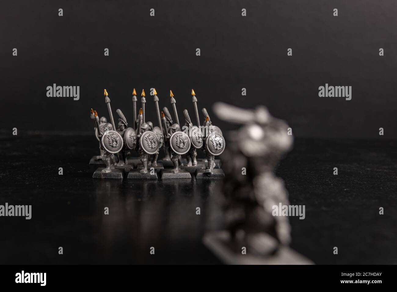 Grayscale selective focus shot of soldier with spears figurines Stock Photo
